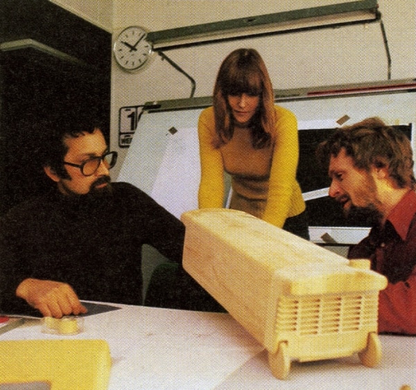 Designers examining the form of a new vacuum model