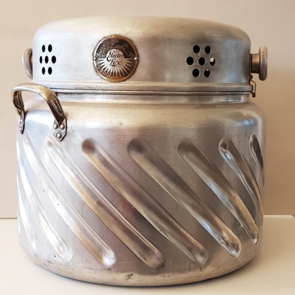 The first Electrolux "washing machine" looked like a large, grooved cauldron which was placed on the cooker to heat up the water while the lid was fitted with a cylinder driven by an electric motor that would rotate the laundry against the grooves