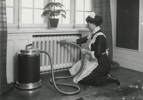 A cleaning lady with the vacuum cleaner Lux I.