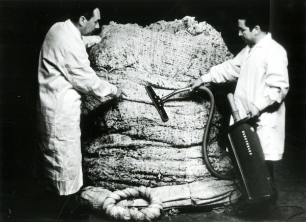 Two men vacuuming a bale, Peru