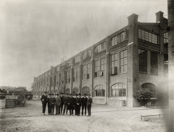 Workers, probably foremen, gathered for a group photo outside of the factory on Lilla Essingen