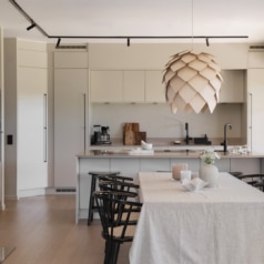 The kitchen island flows directly into the dining and living spaces