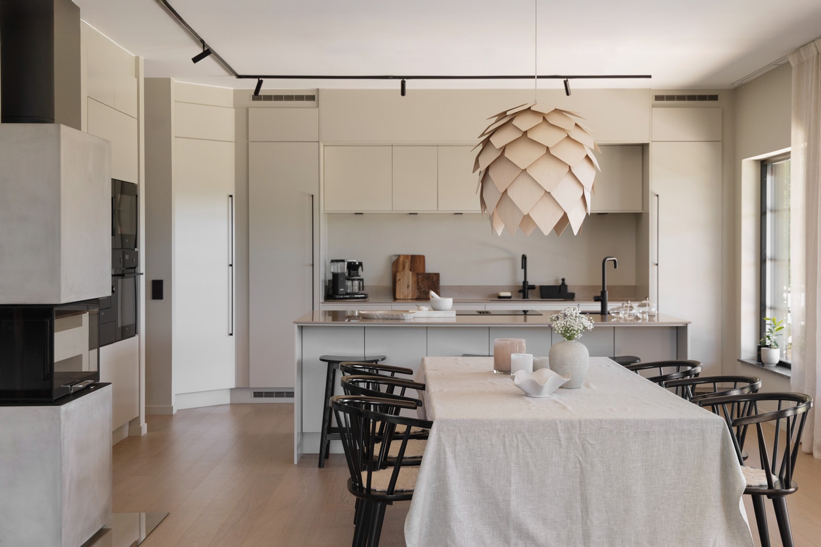 The kitchen island flows directly into the dining and living spaces